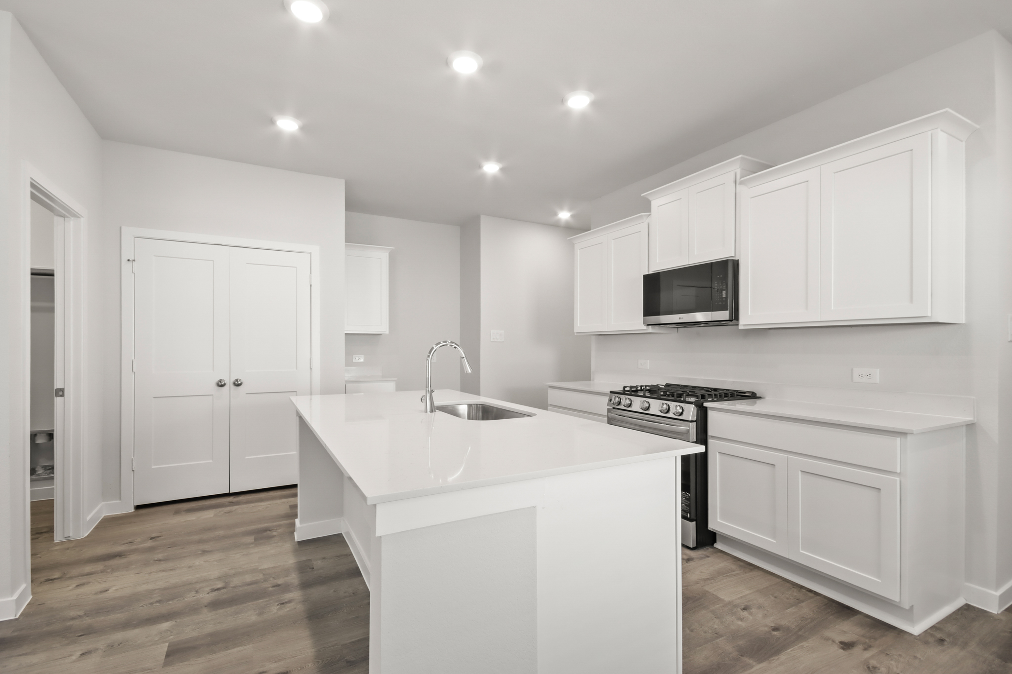A kitchen with white cabinets.