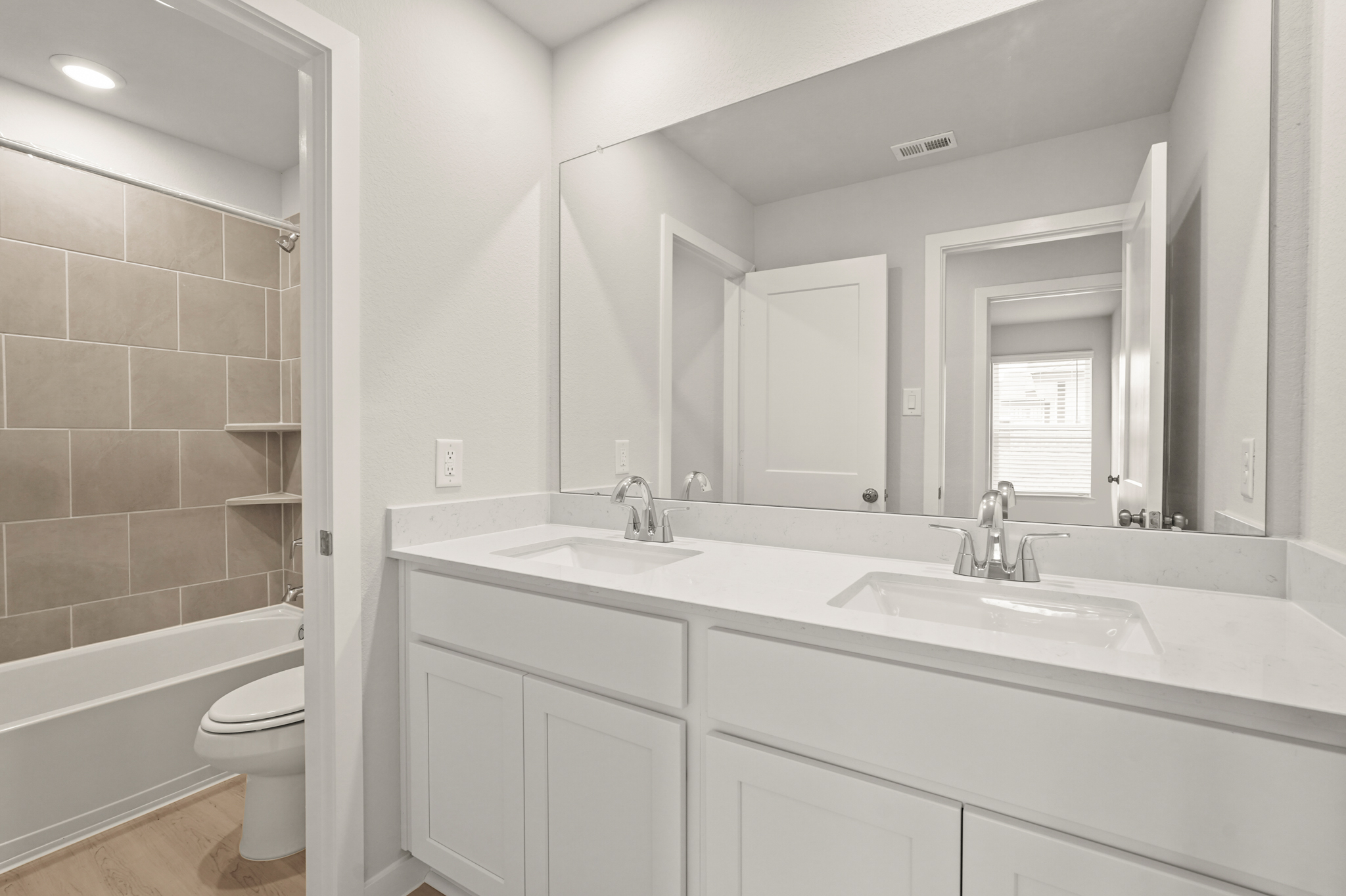 A bathroom with a tub sink and toilet.