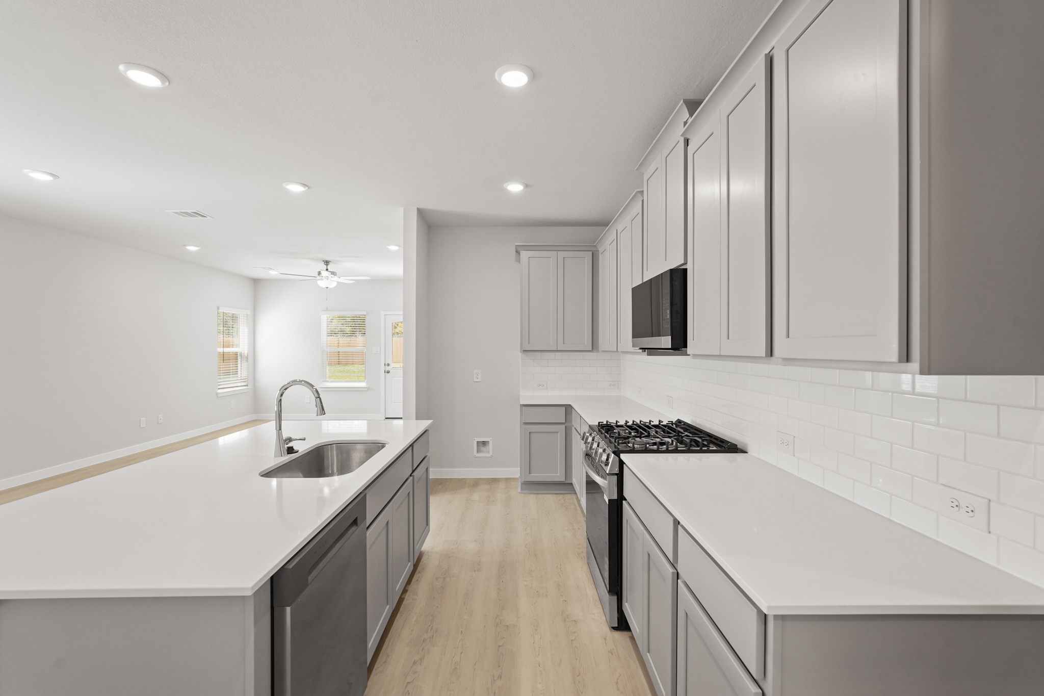 A kitchen with white cabinets.