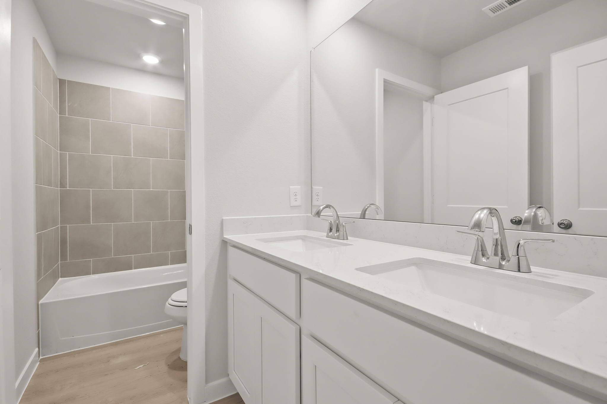 A bathroom with a tub sink and toilet.
