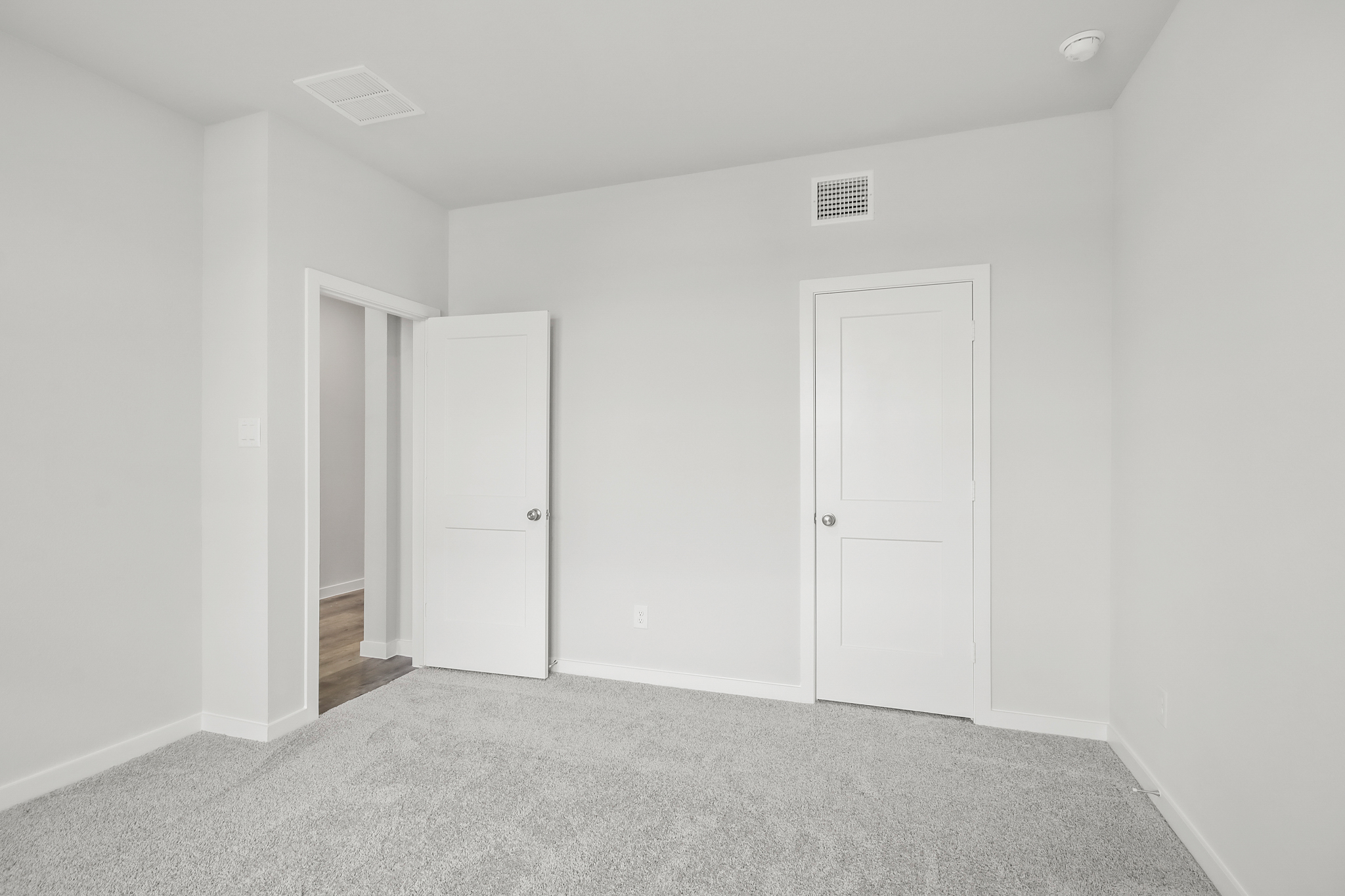 A hallway with white doors.
