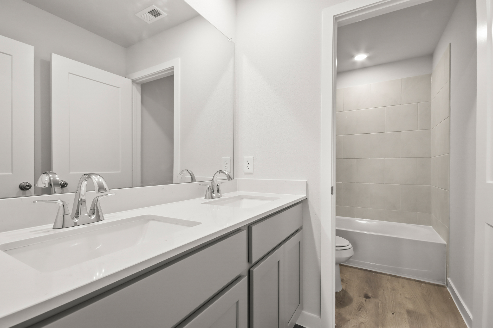 A bathroom with a tub sink and toilet.