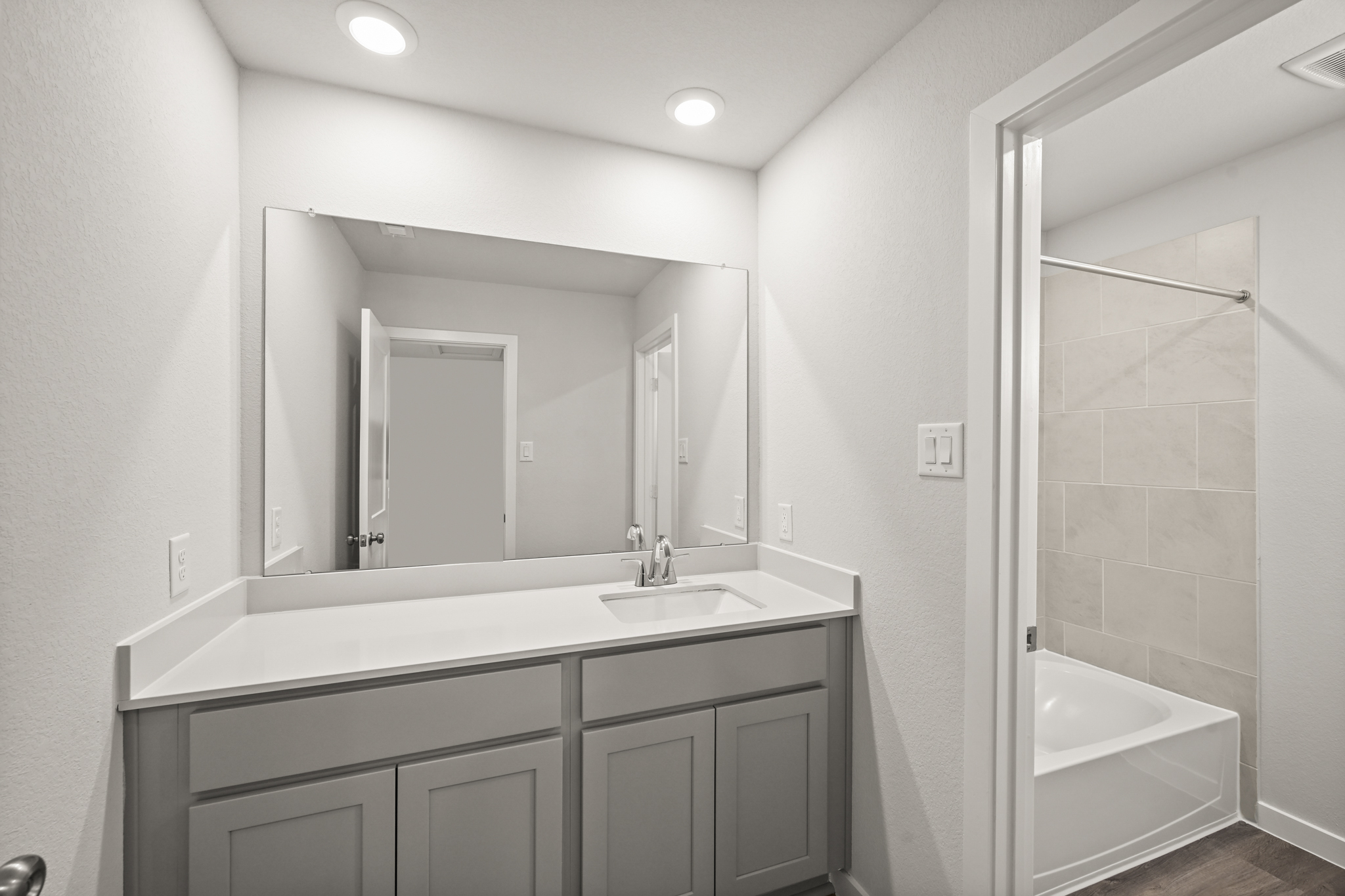 A bathroom with a sink and a bathtub.