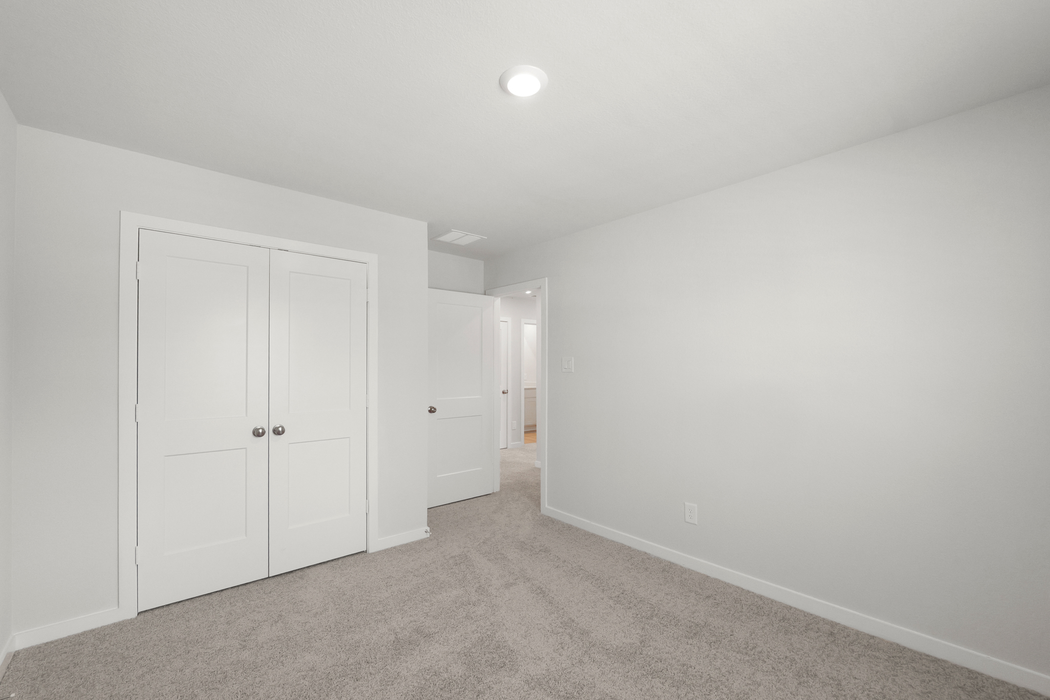 A hallway with white doors.