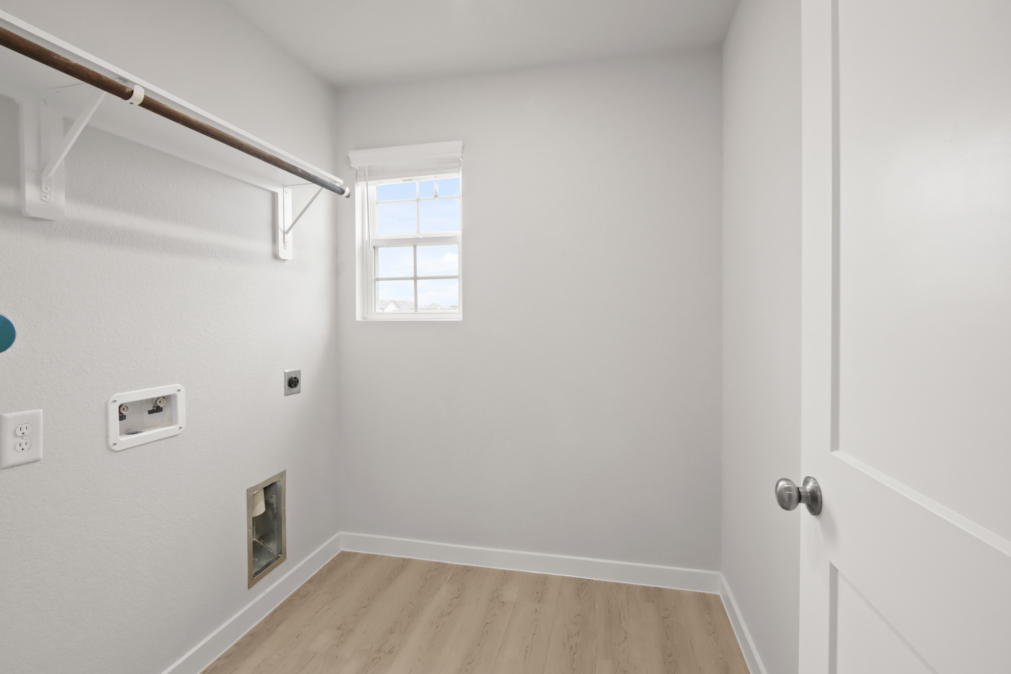 A room with a wood floor and white walls.