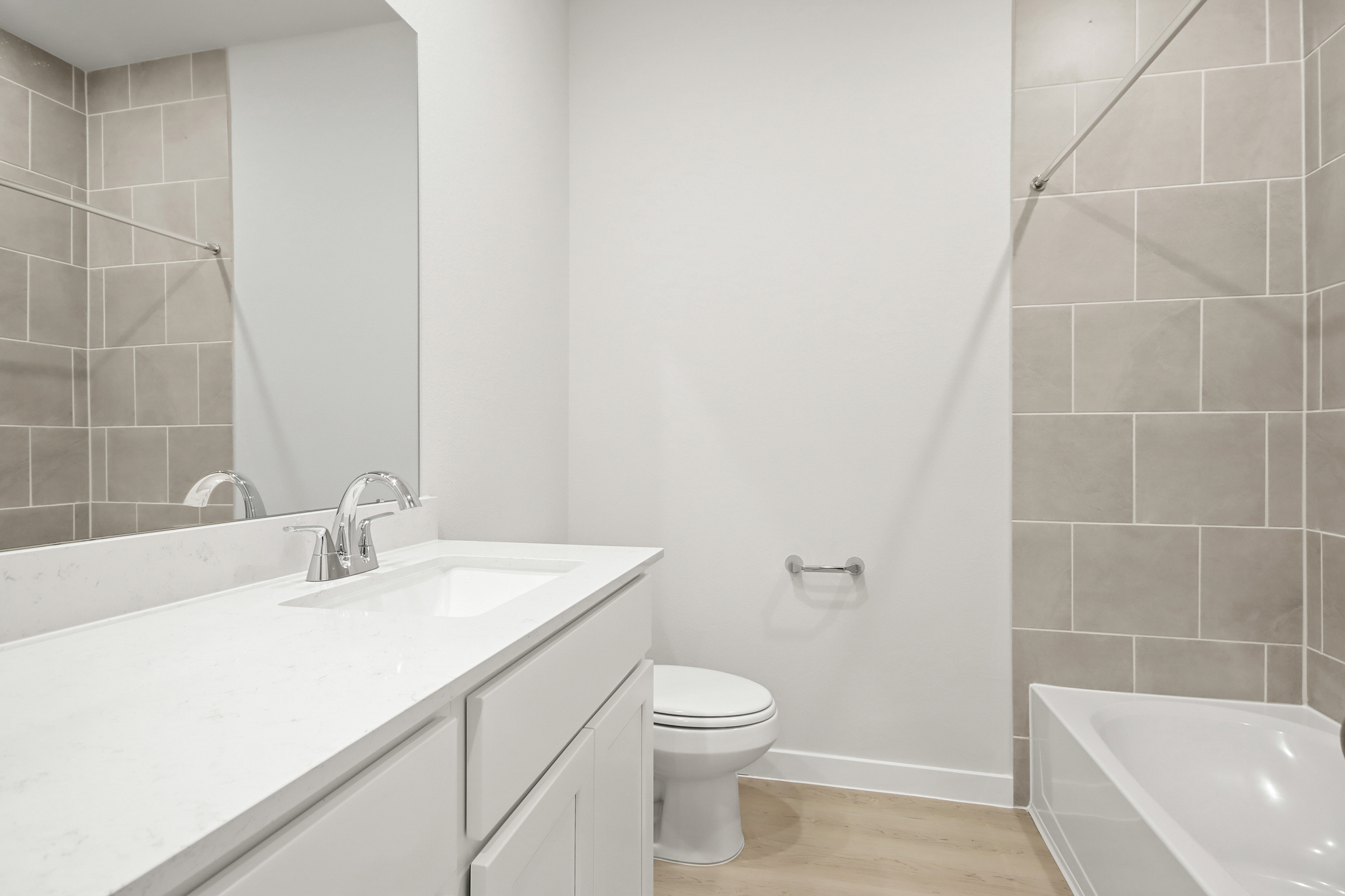 A bathroom with a toilet sink and a bathtub.
