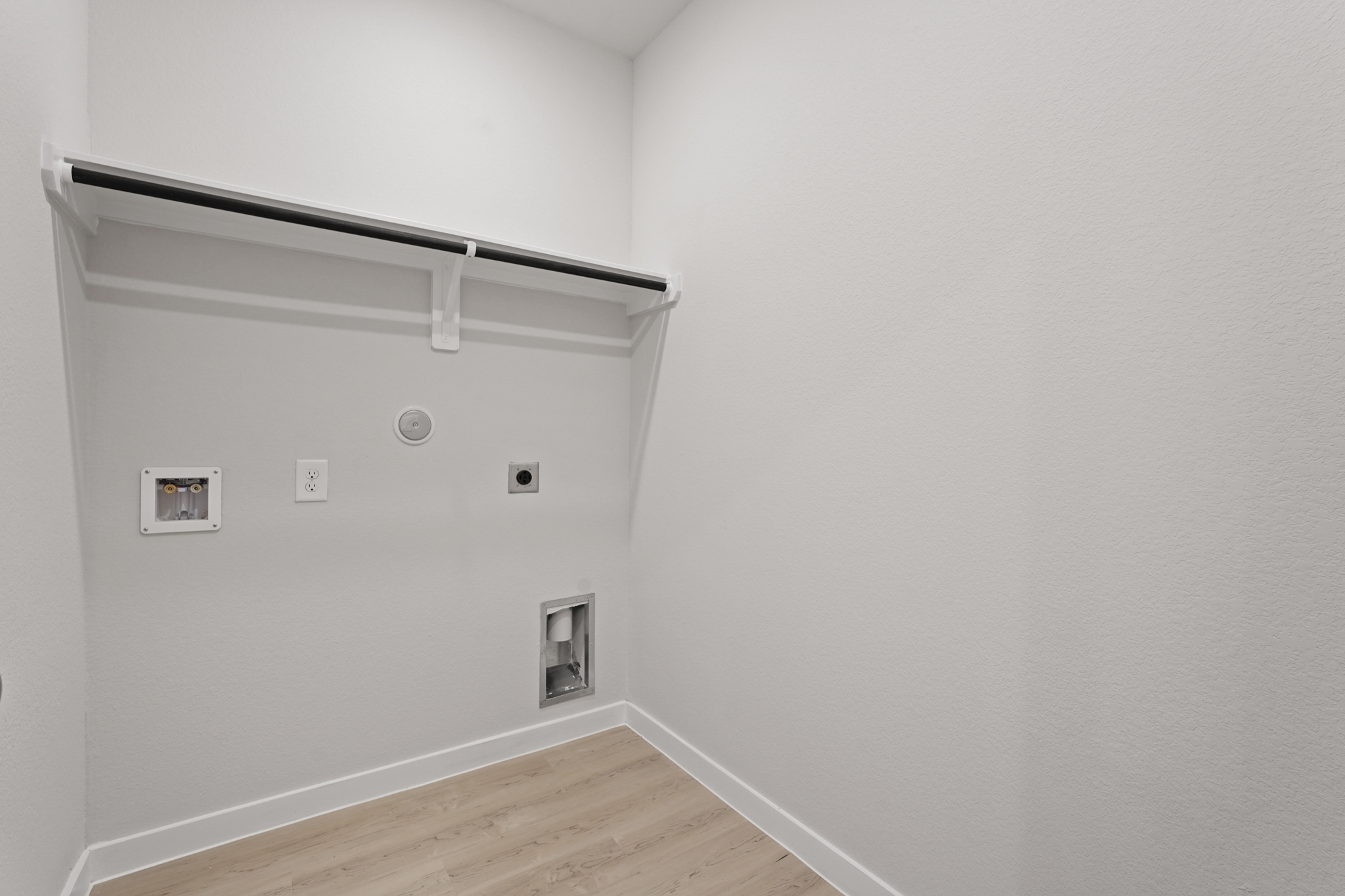 A white wall with a light on it.