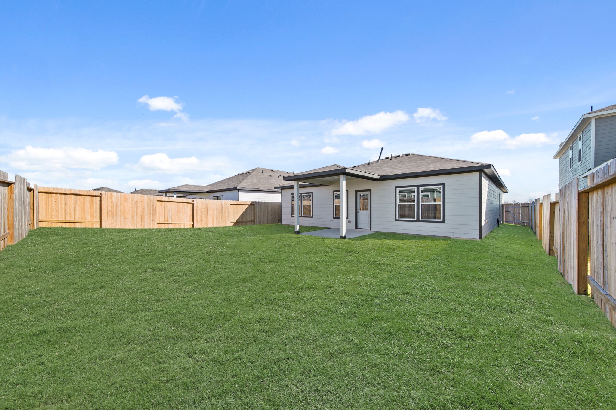 A grassy area with buildings in the background.