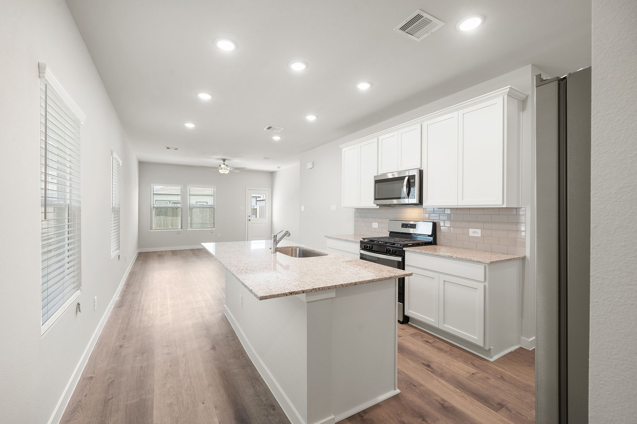 A kitchen with white cabinets.
