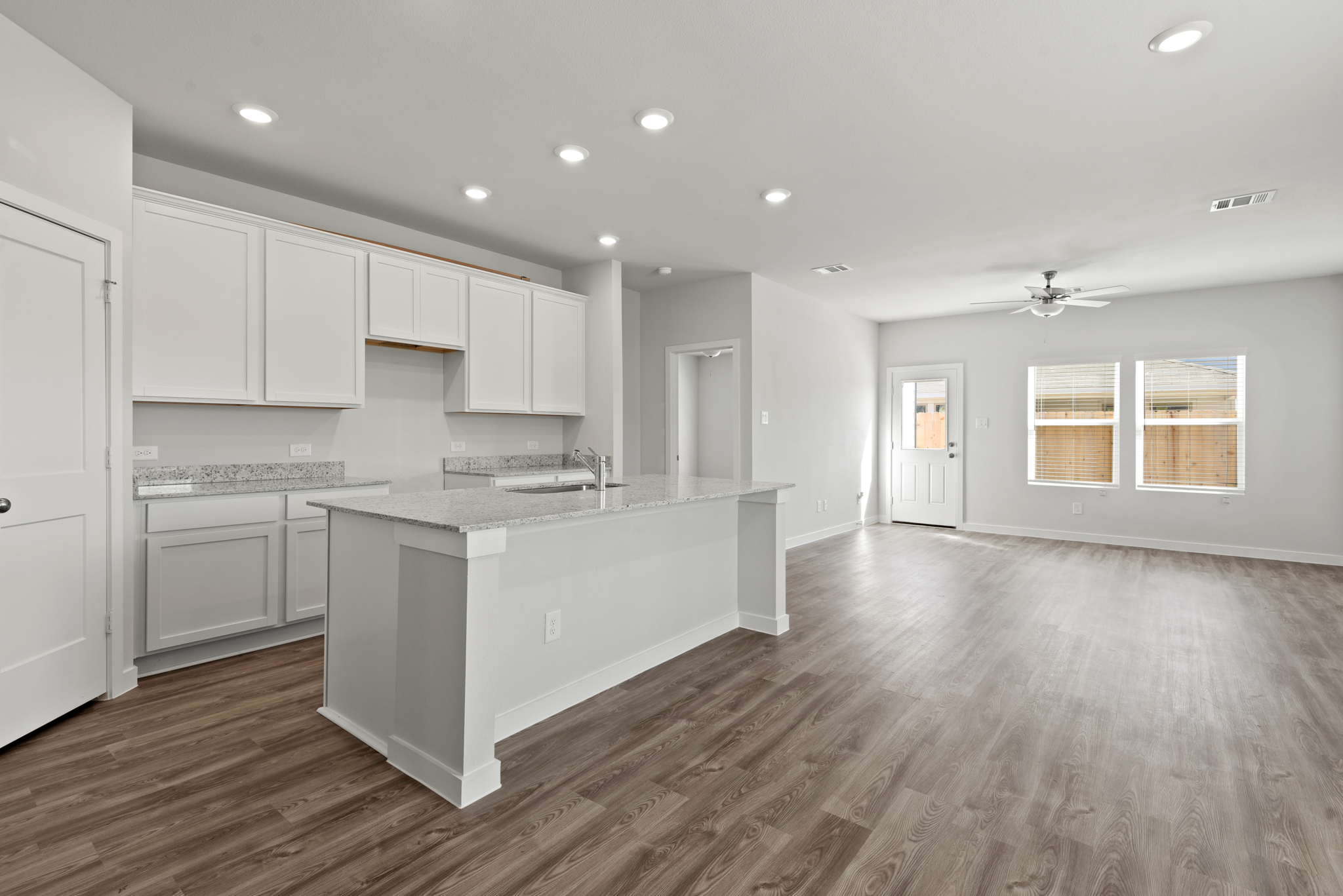 A kitchen with white cabinets.