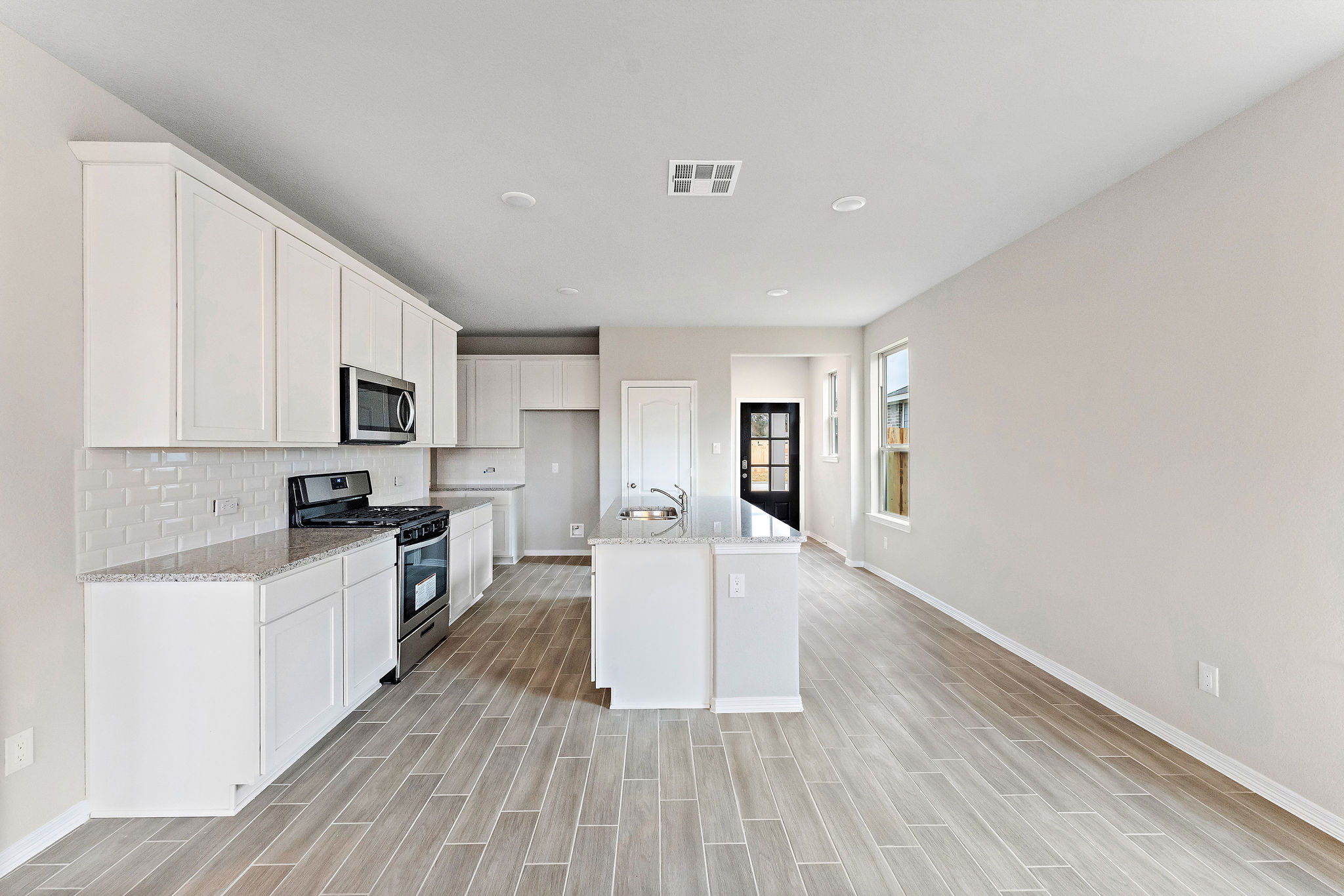 A kitchen with white cabinets.