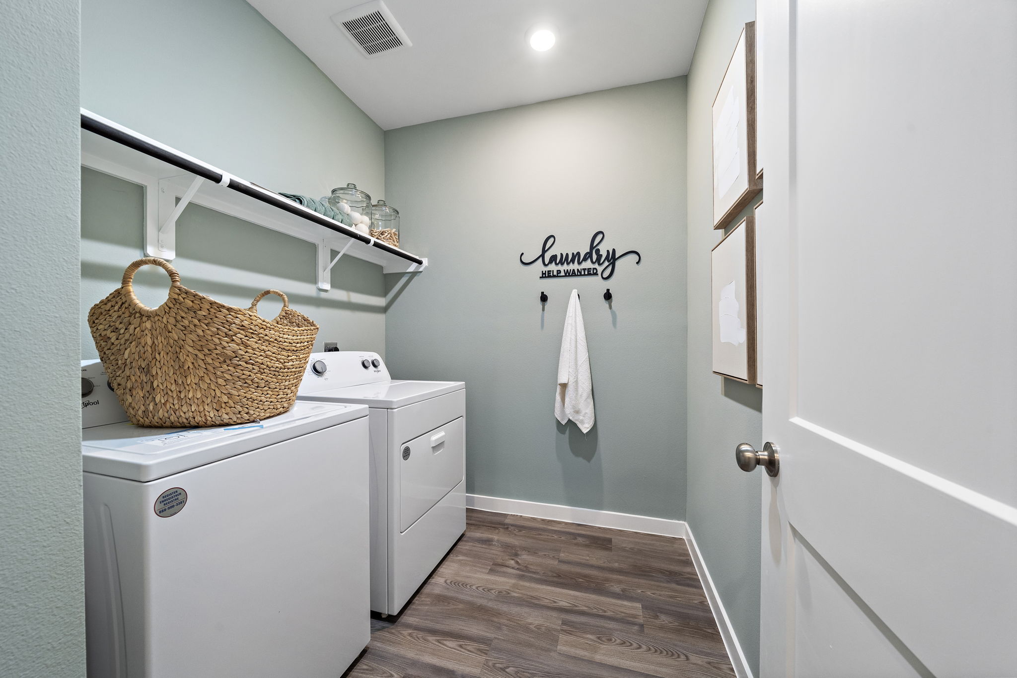 A laundry room with a basket on the wall.