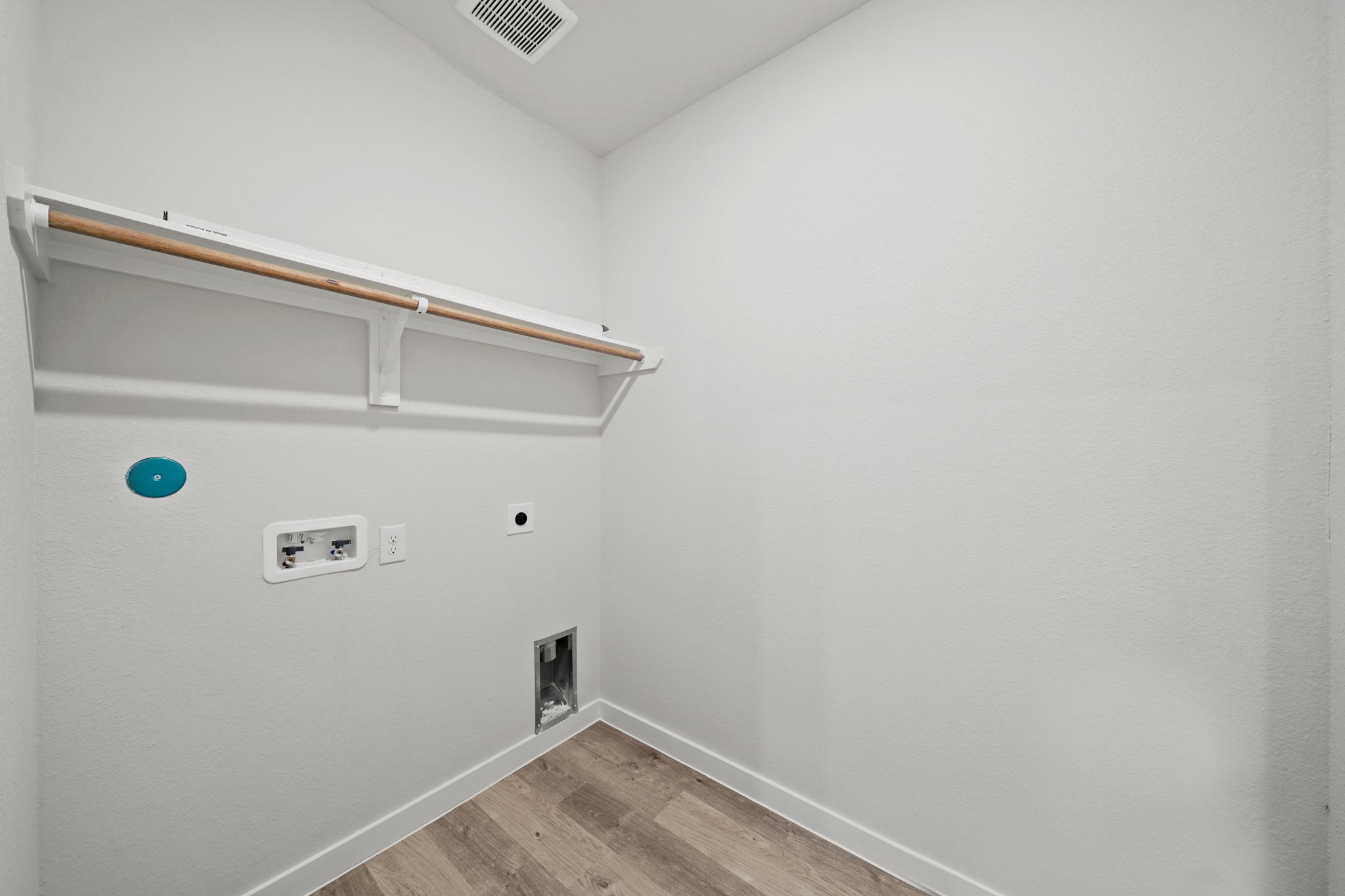 A white room with a wood floor.