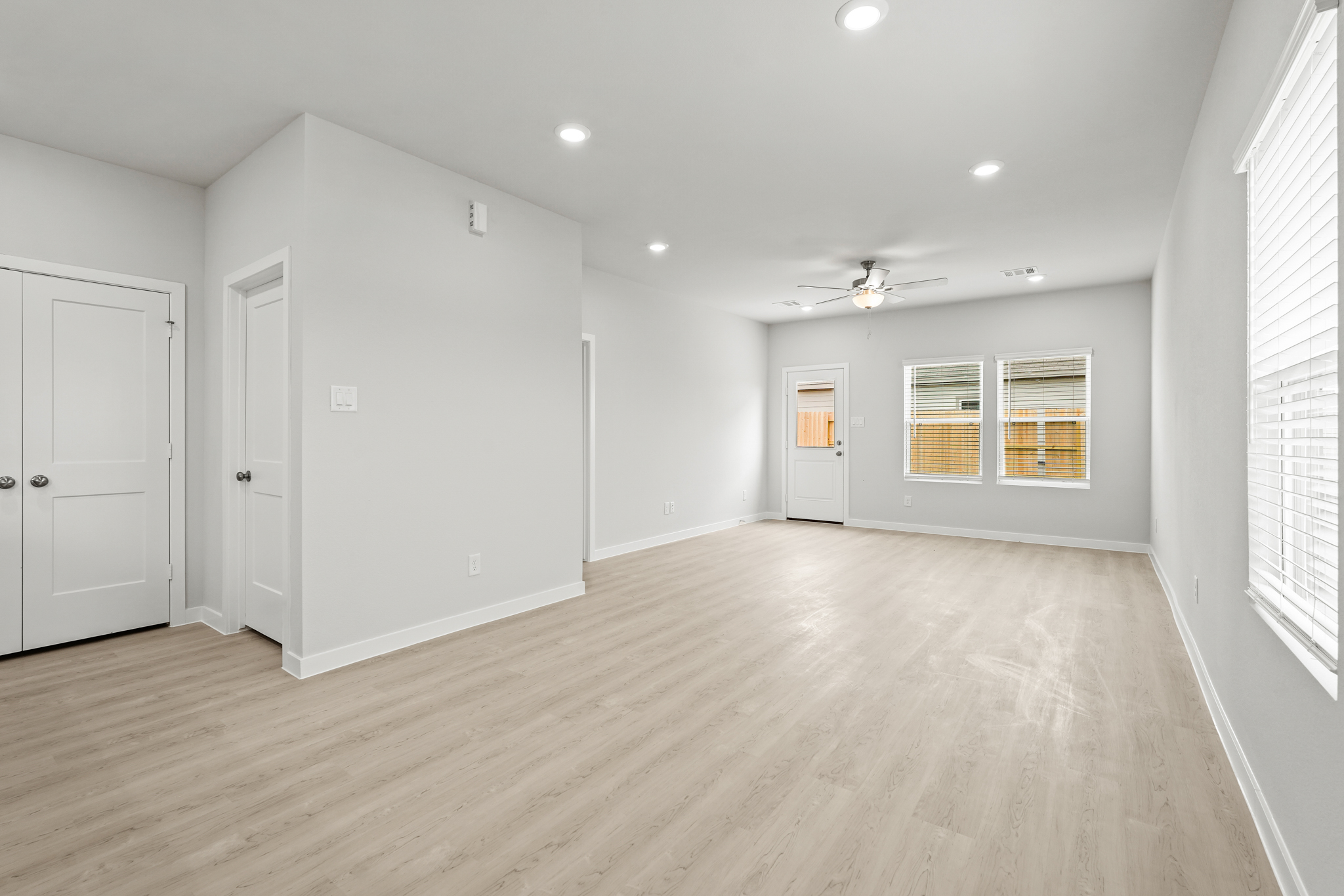 A room with white walls and wood floors.