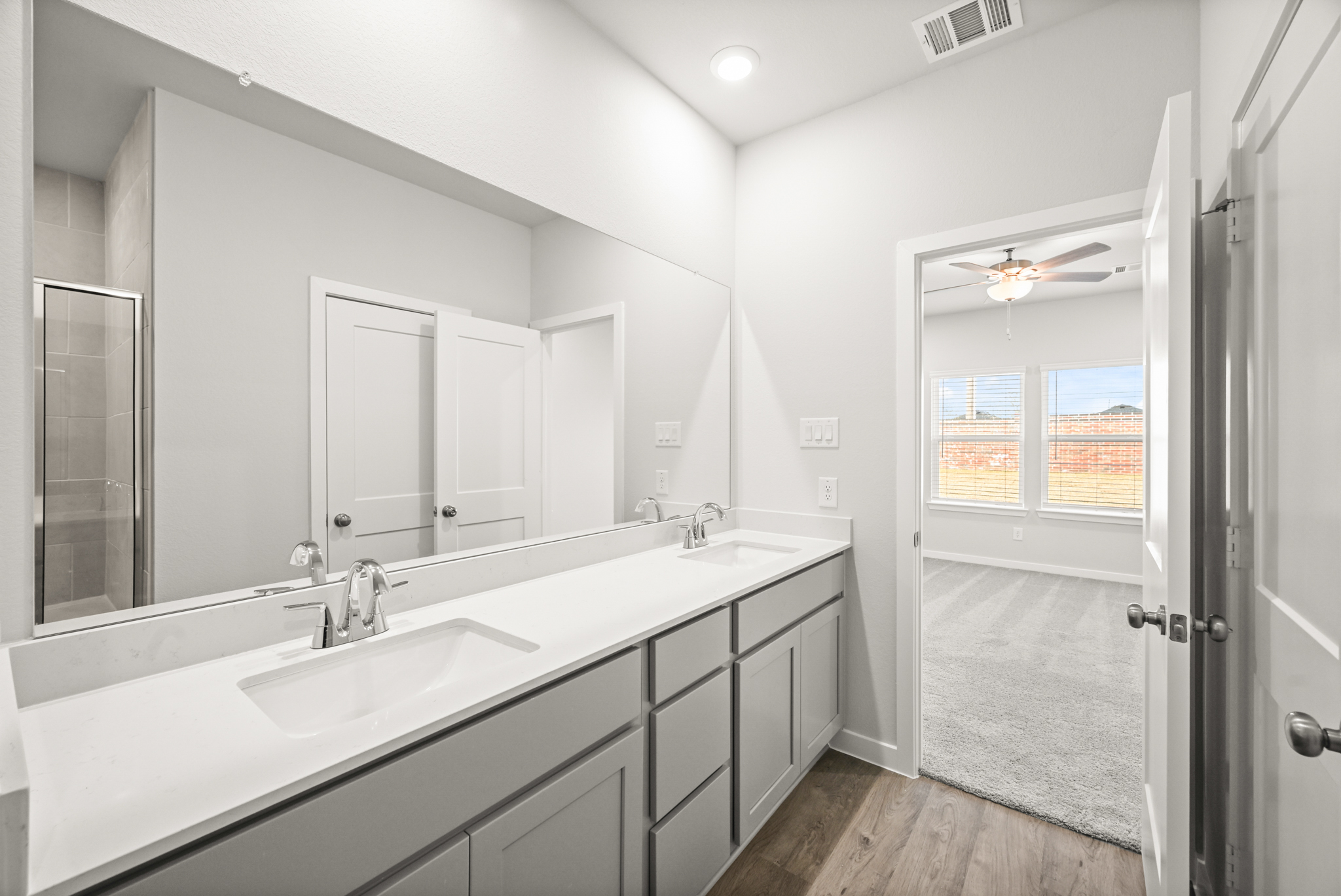 A bathroom with a large mirror.