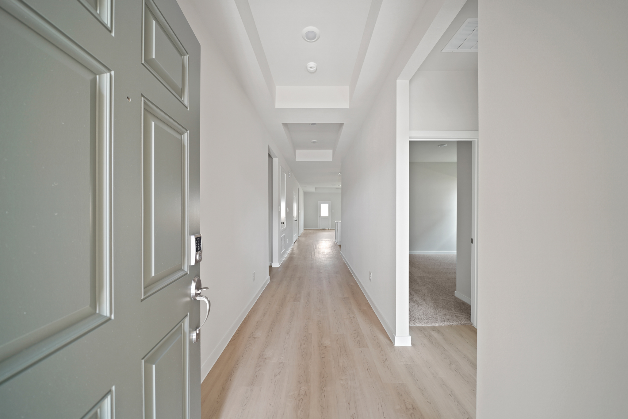A hallway with white walls.