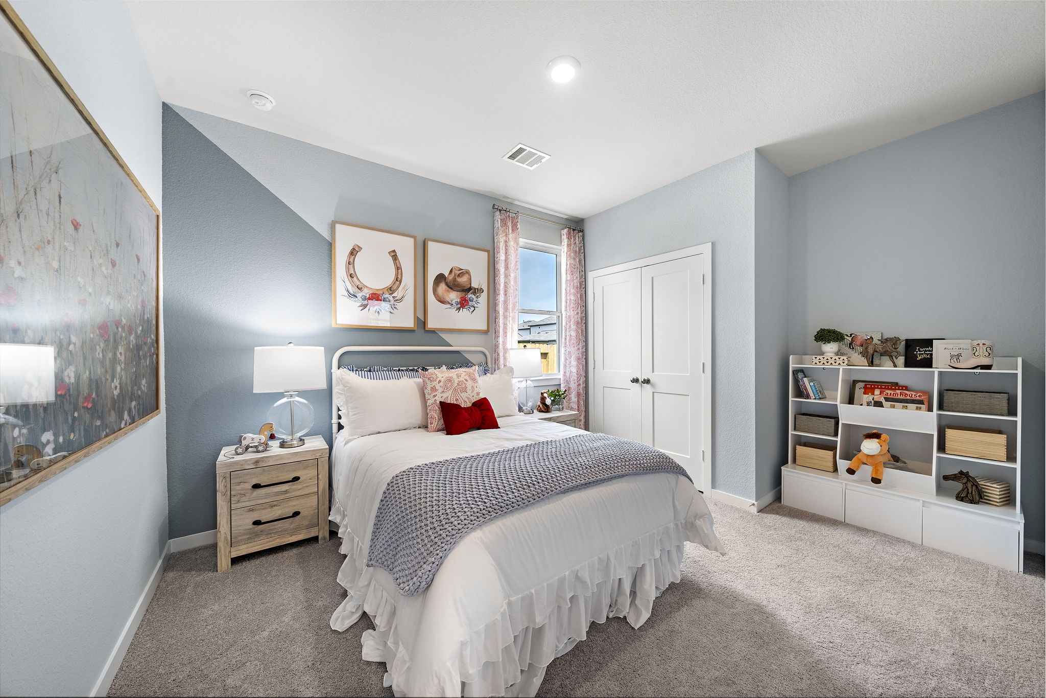 A bedroom with a bed and a shelf.
