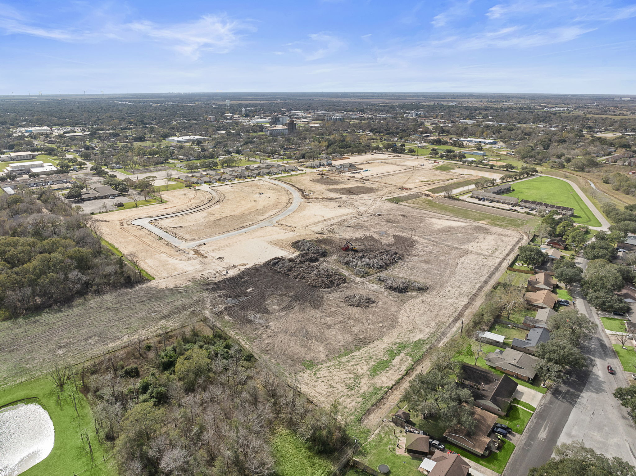 A landscape with a river and buildings.