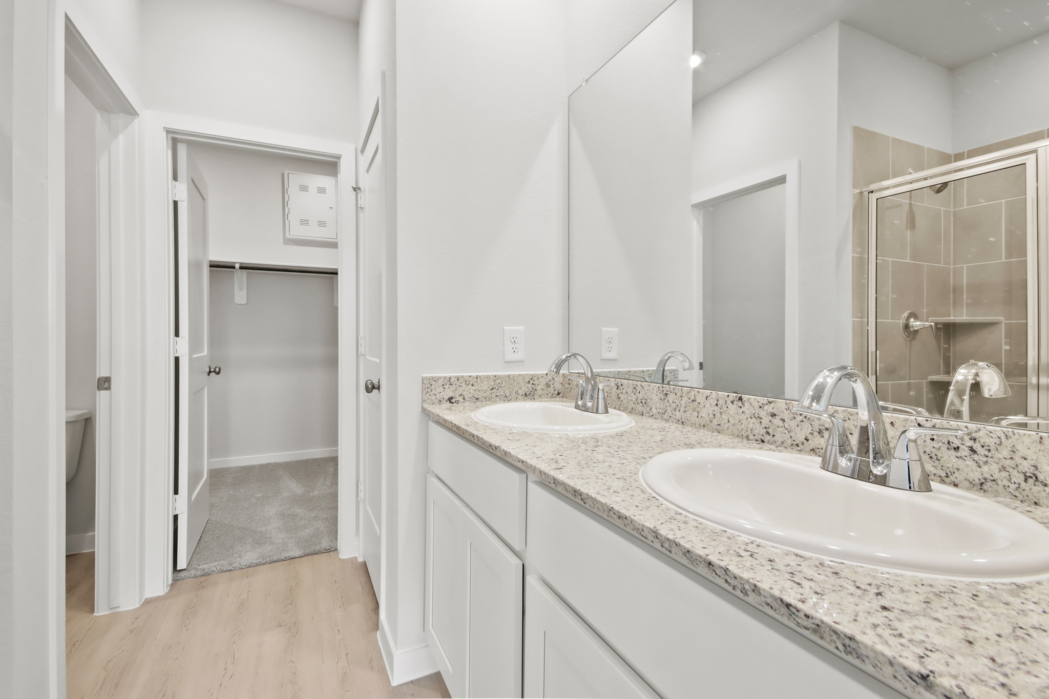 A bathroom with a large mirror.
