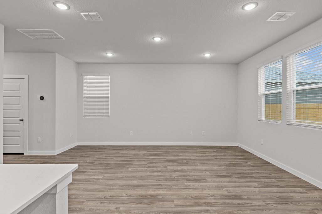 A room with a wood floor and white walls.
