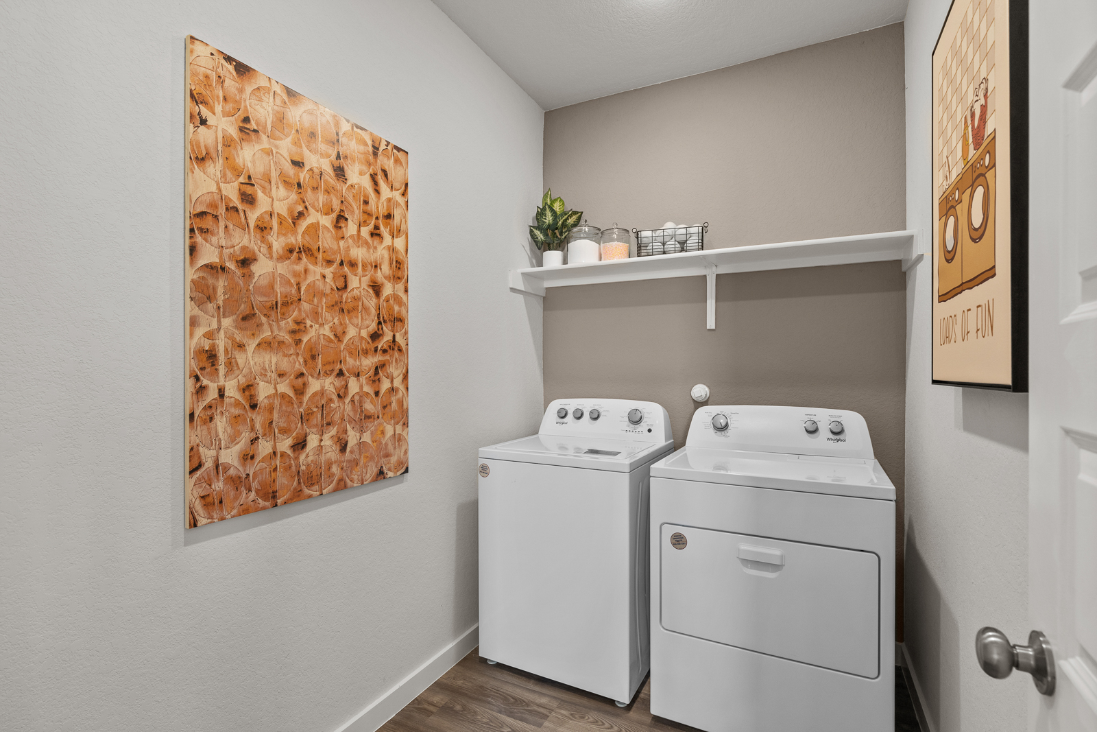 A room with white cabinets and a white washing machine.