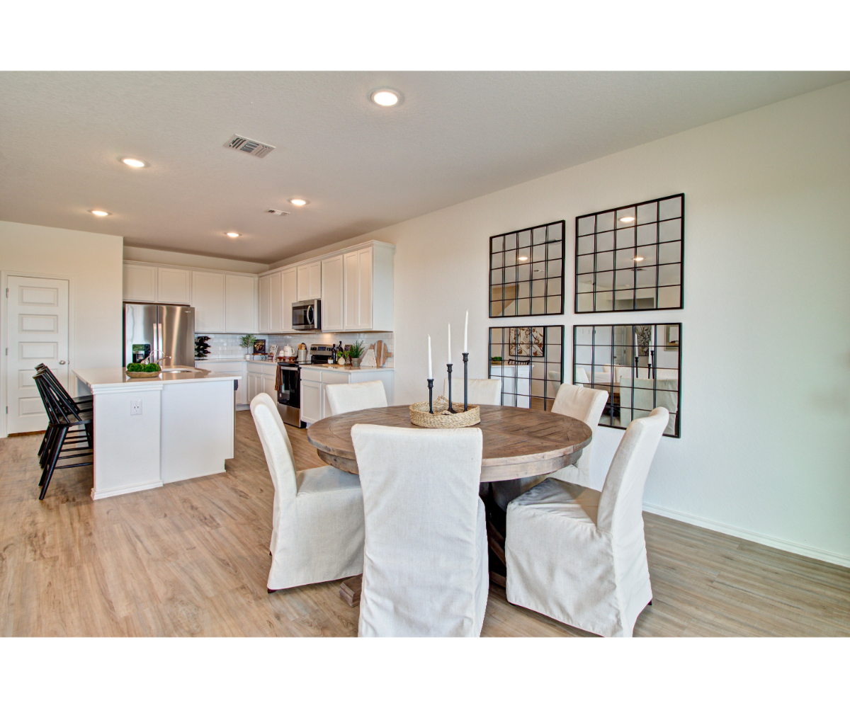 A large kitchen with a dining table.