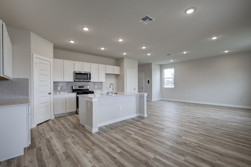 A kitchen with white cabinets.