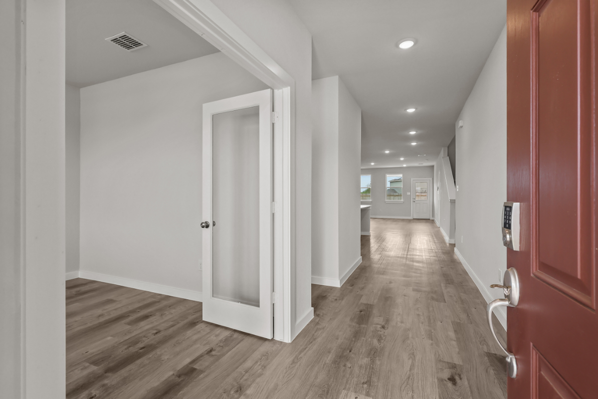 A hallway with white doors.