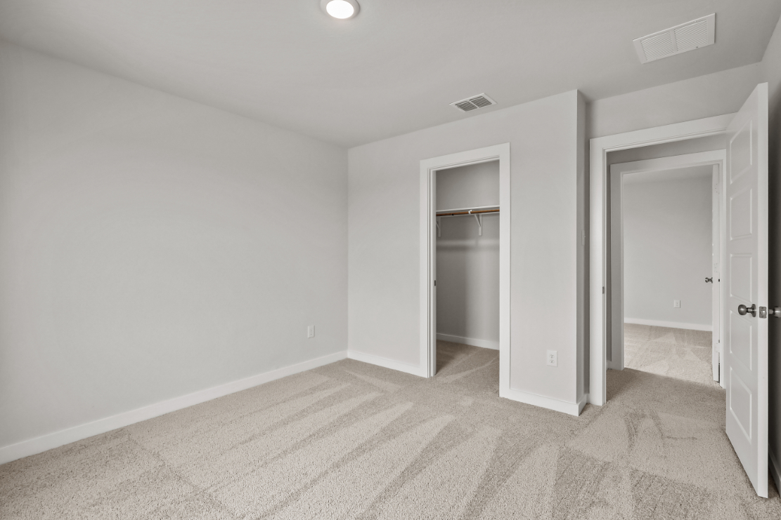 A room with a door and a shelf.