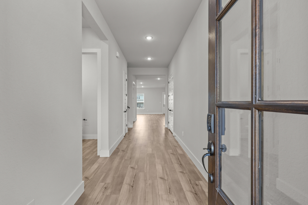 A hallway with glass doors.