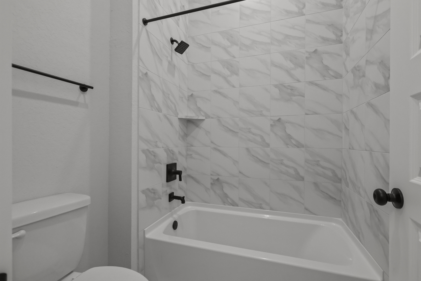 A shower with a glass wall.