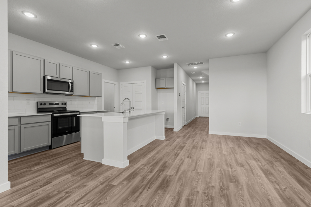 A kitchen with white cabinets.
