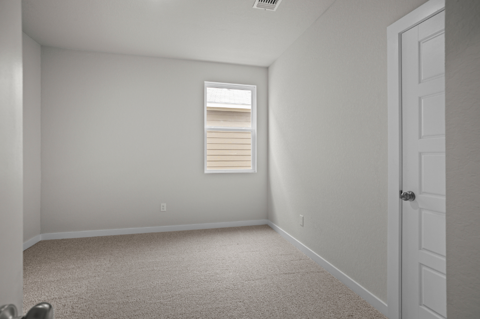 A room with white walls and a window.