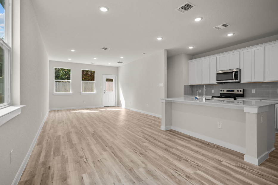 A kitchen with white cabinets.