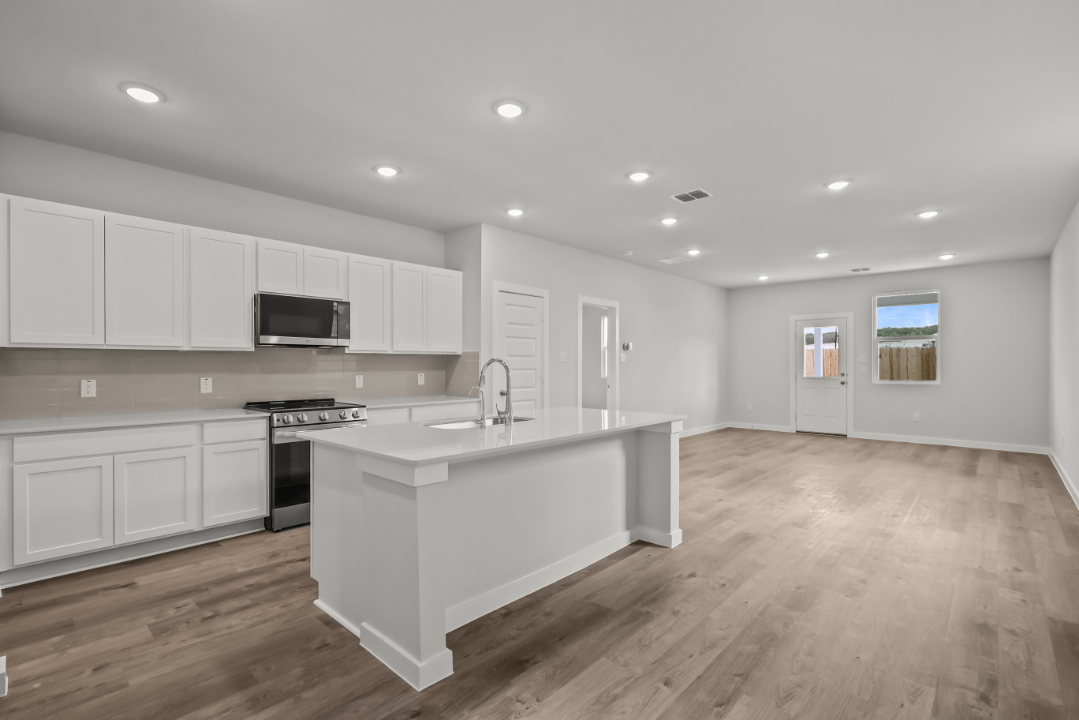 A kitchen with white cabinets.