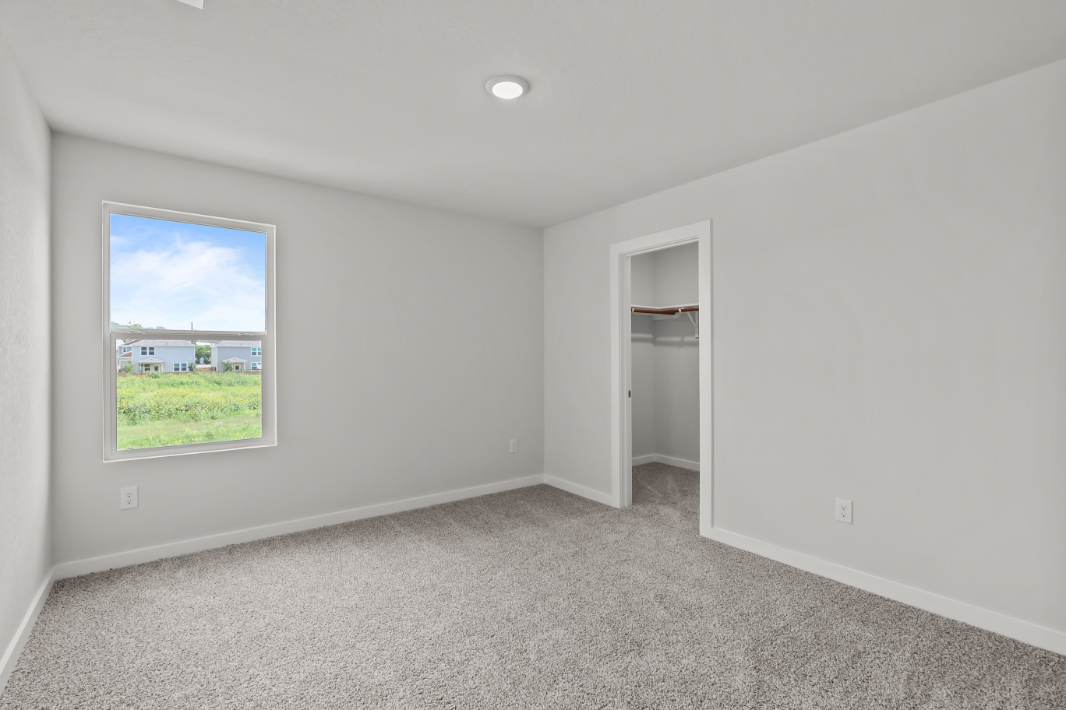 A room with a window and a door.