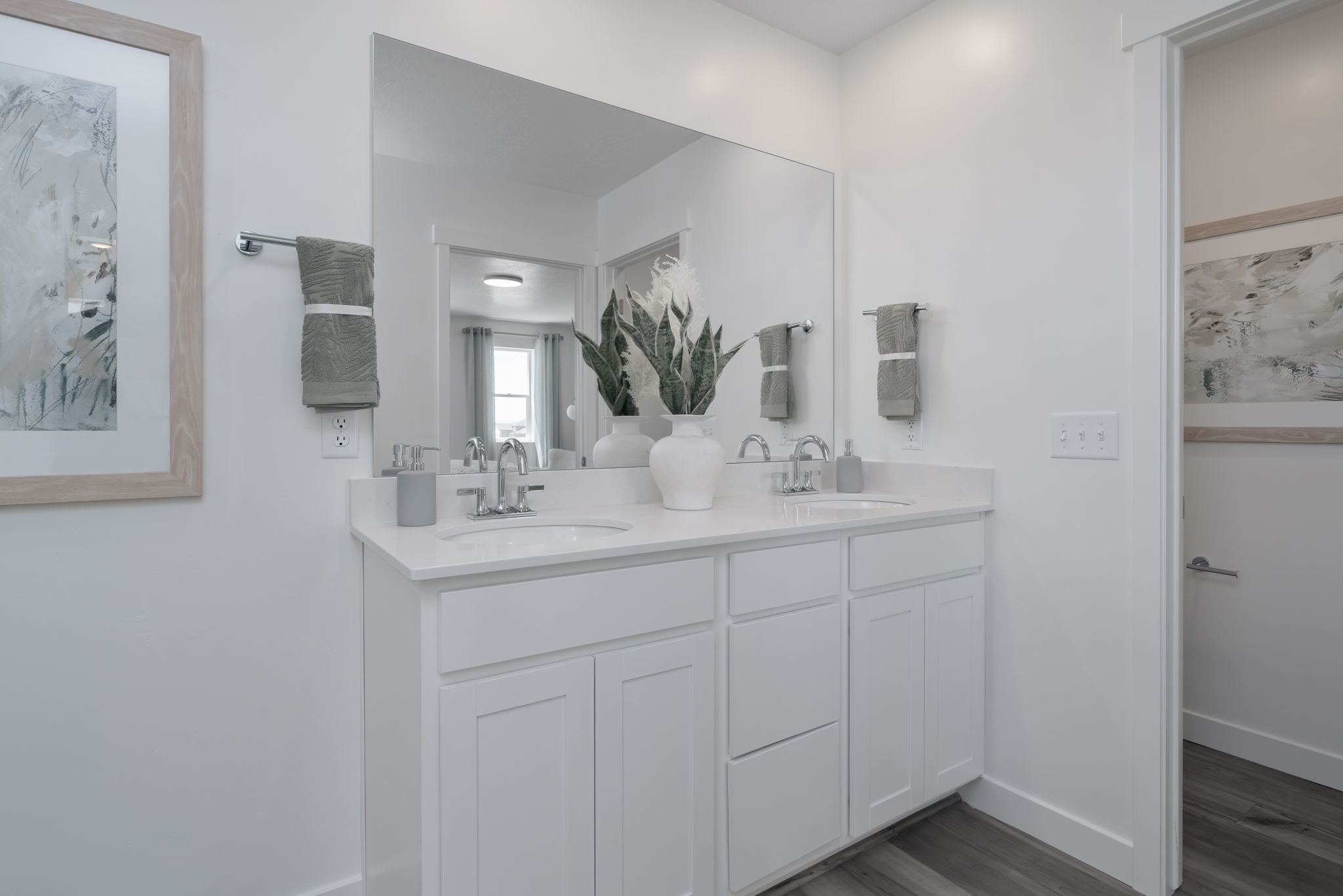A bathroom with white cabinets.
