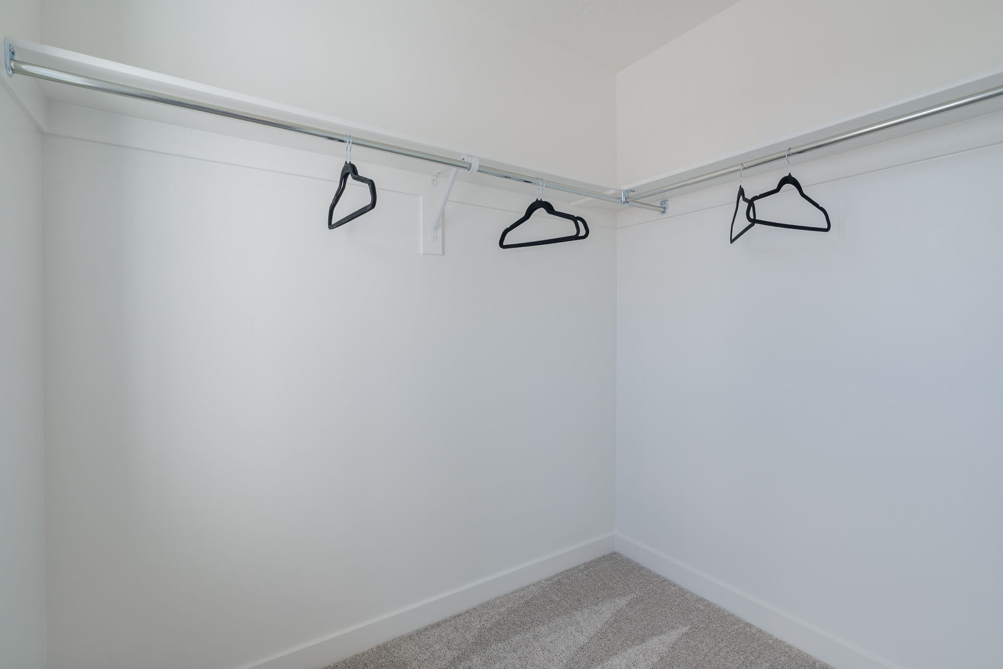 A white wall with a black circle and a black circle on it.