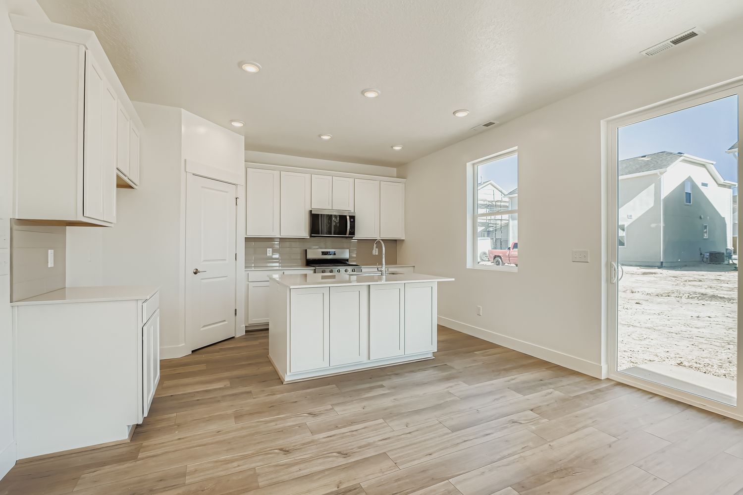 A kitchen with white cabinets.