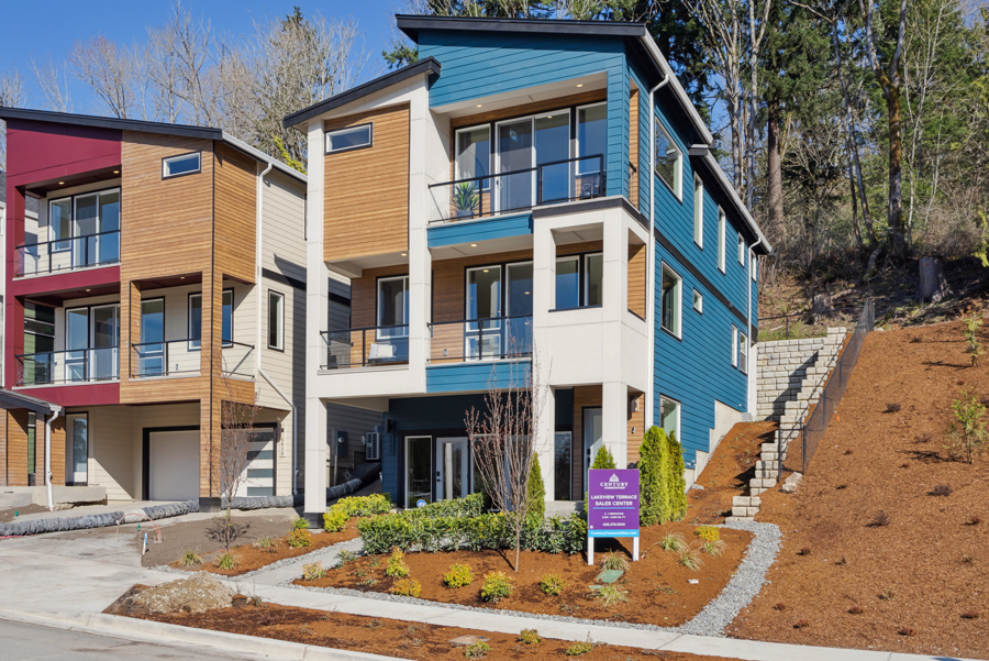 A multi-story building with a sign in front of it.