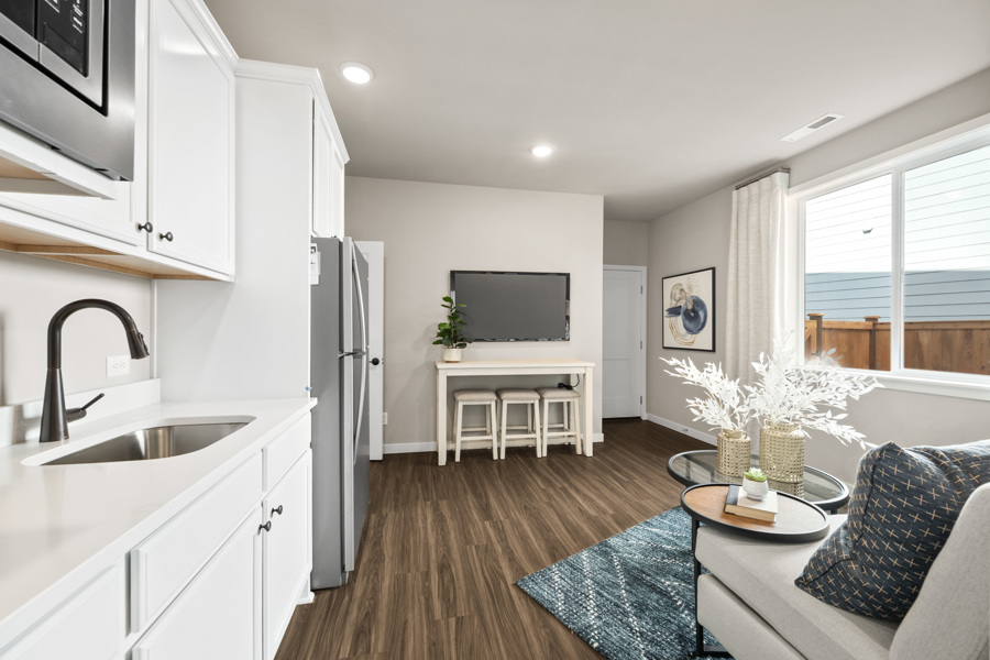 A kitchen with a sink and a tv.