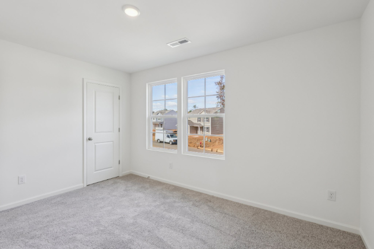 A room with a window and a door.