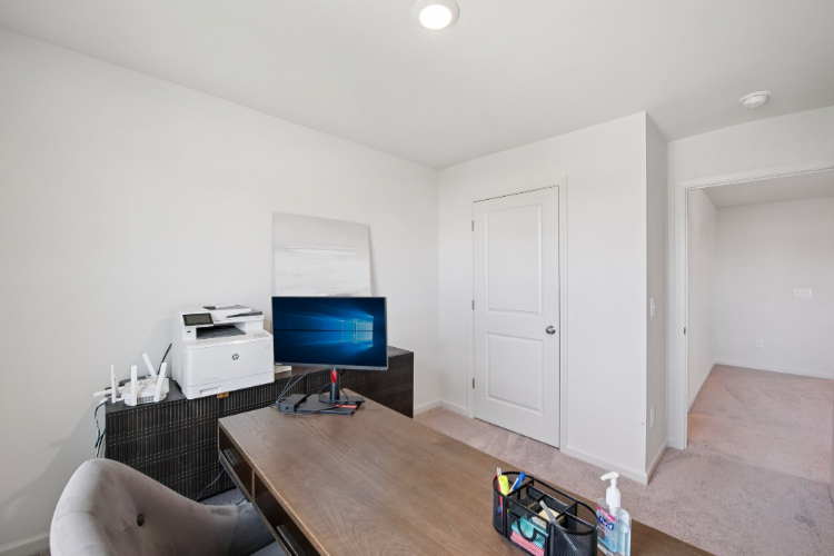 A room with a table and a tv and a chair.