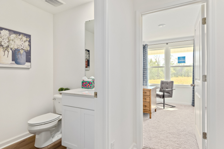 A bathroom with a chair and a sink.
