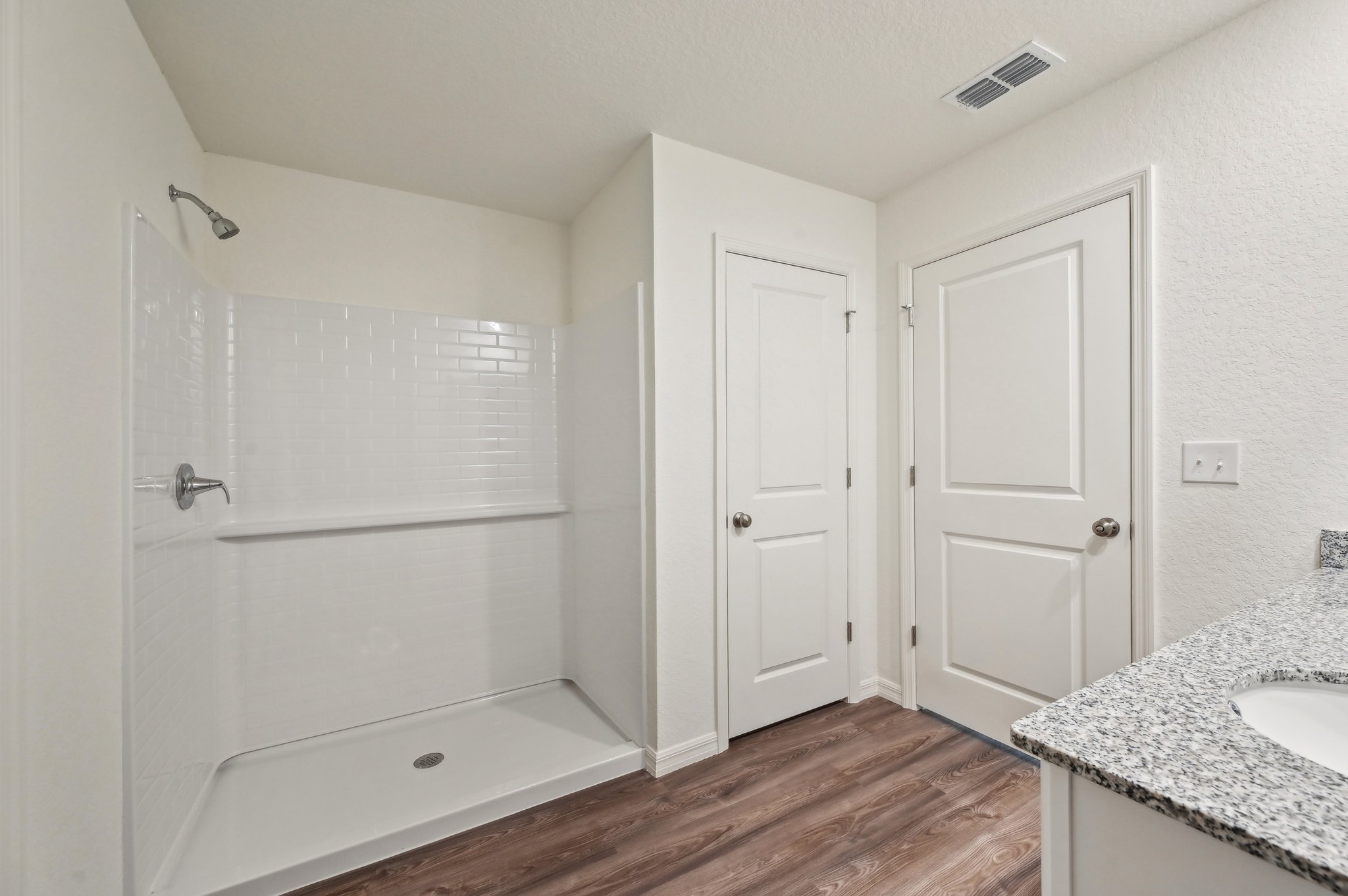 A bathroom with white cabinets.