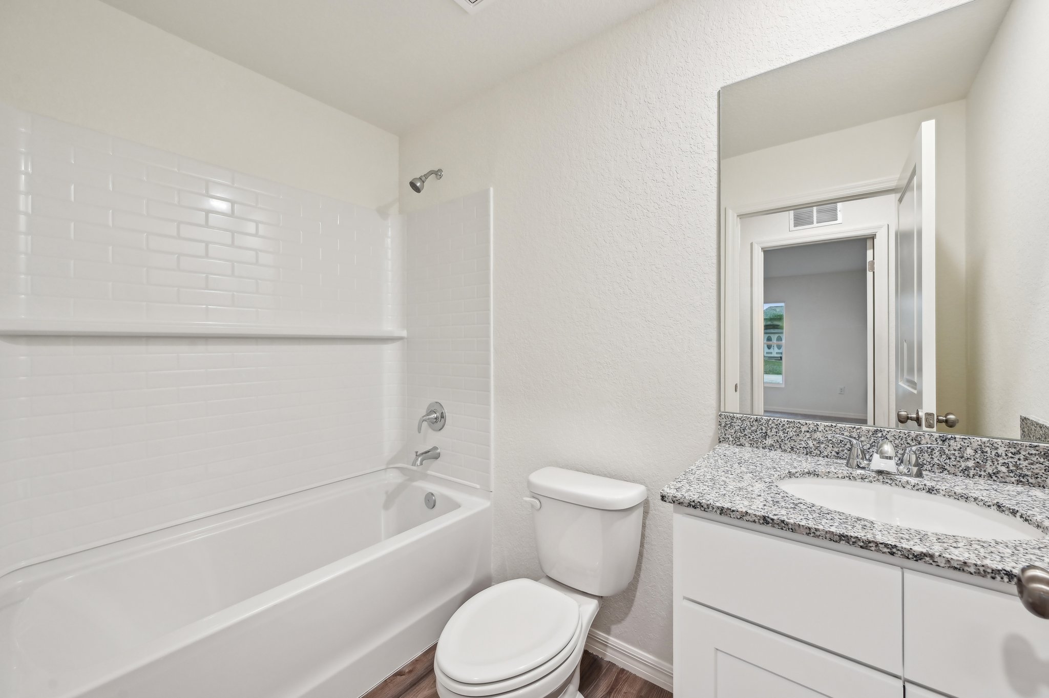 A bathroom with a tub sink and toilet.
