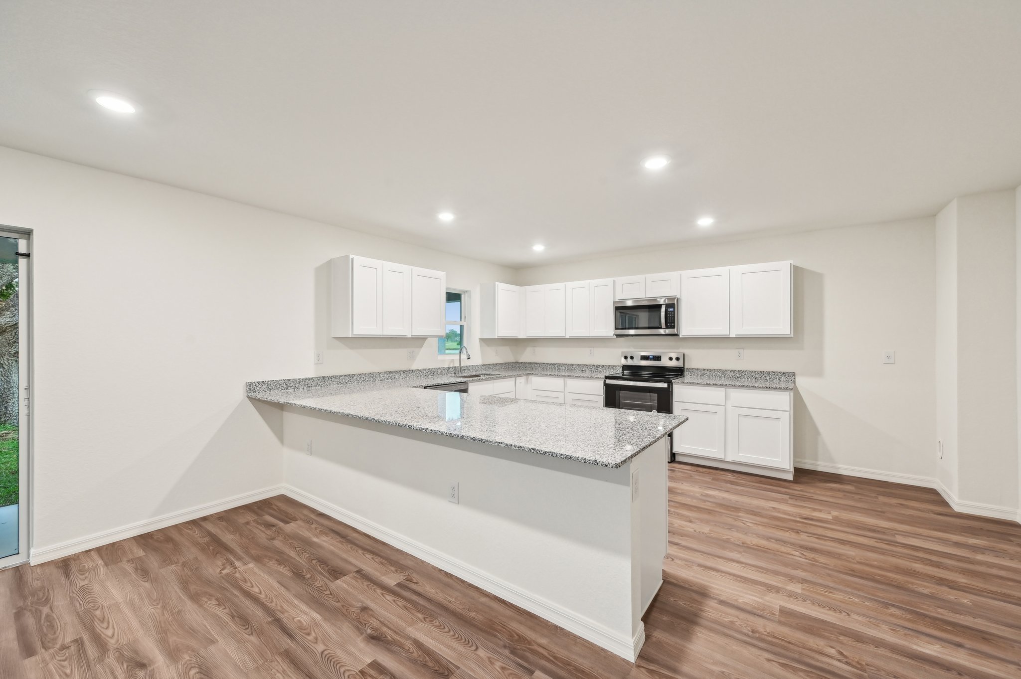 A kitchen with white cabinets.