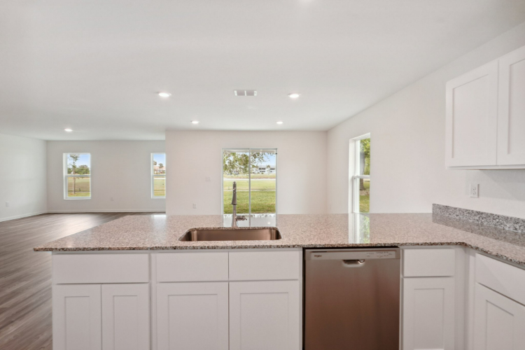 A kitchen with marble counters.