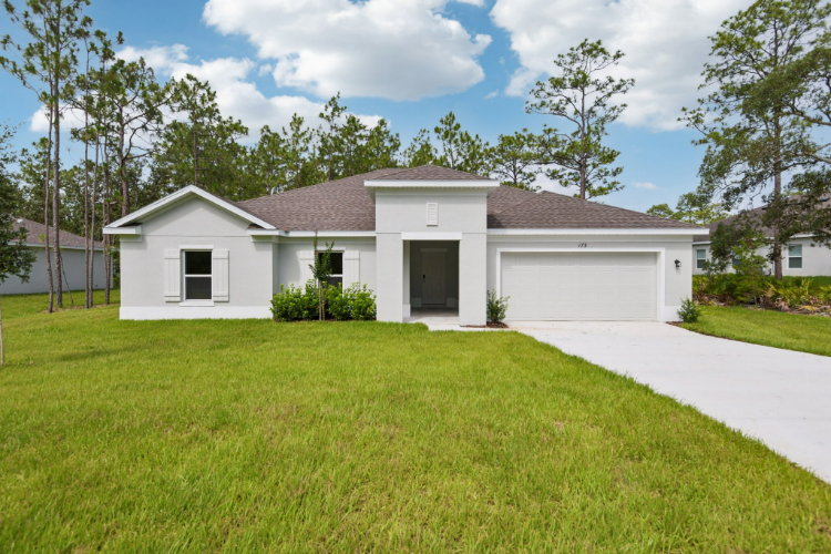 A white house with a driveway.