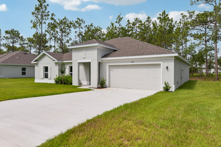 A white house with a driveway.